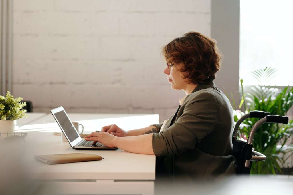 woman doing work remotely using laptop